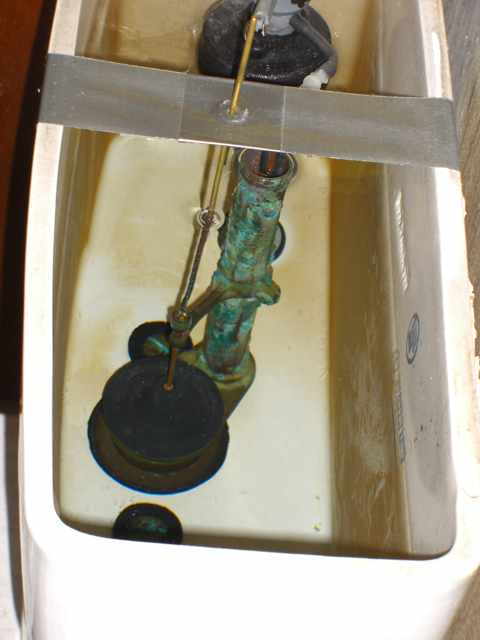 Photo showing interior of tank with rod running from the center of the duck tape to the valve bulb.